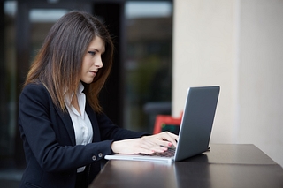 A woman works on her laptop