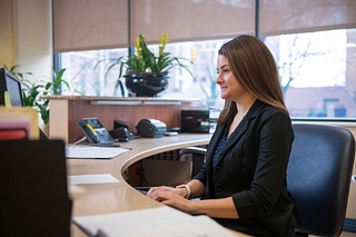 A health information technology professional works on her computer at the hospital